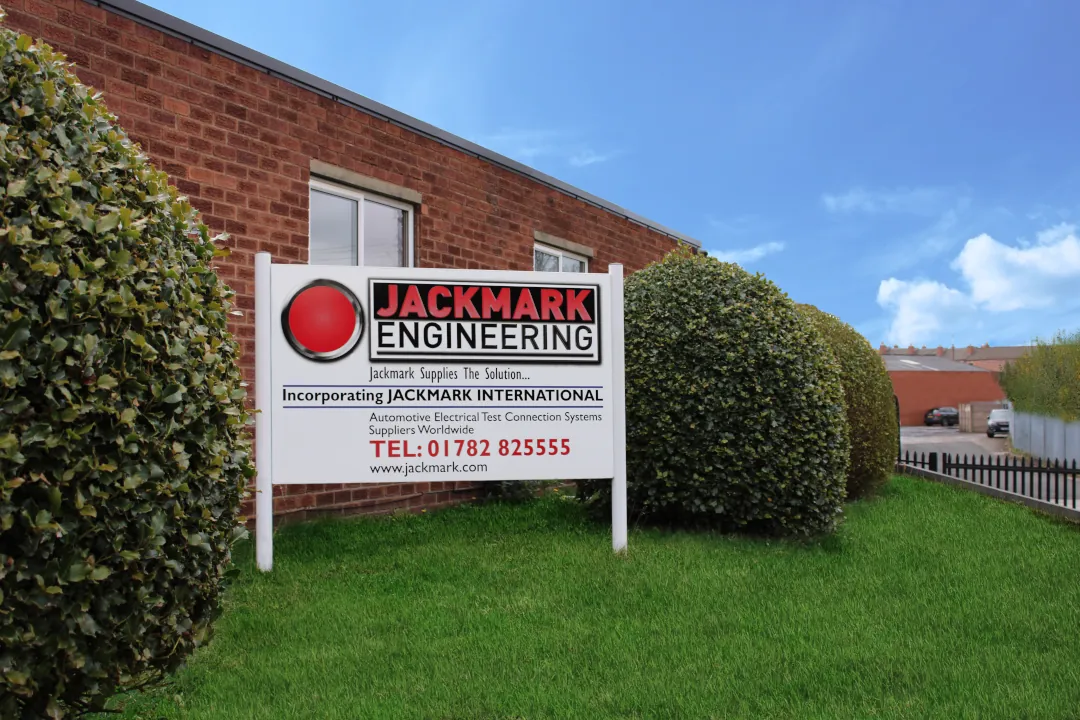 Jackmark Engineering sign on a grass hill outside a brick building
